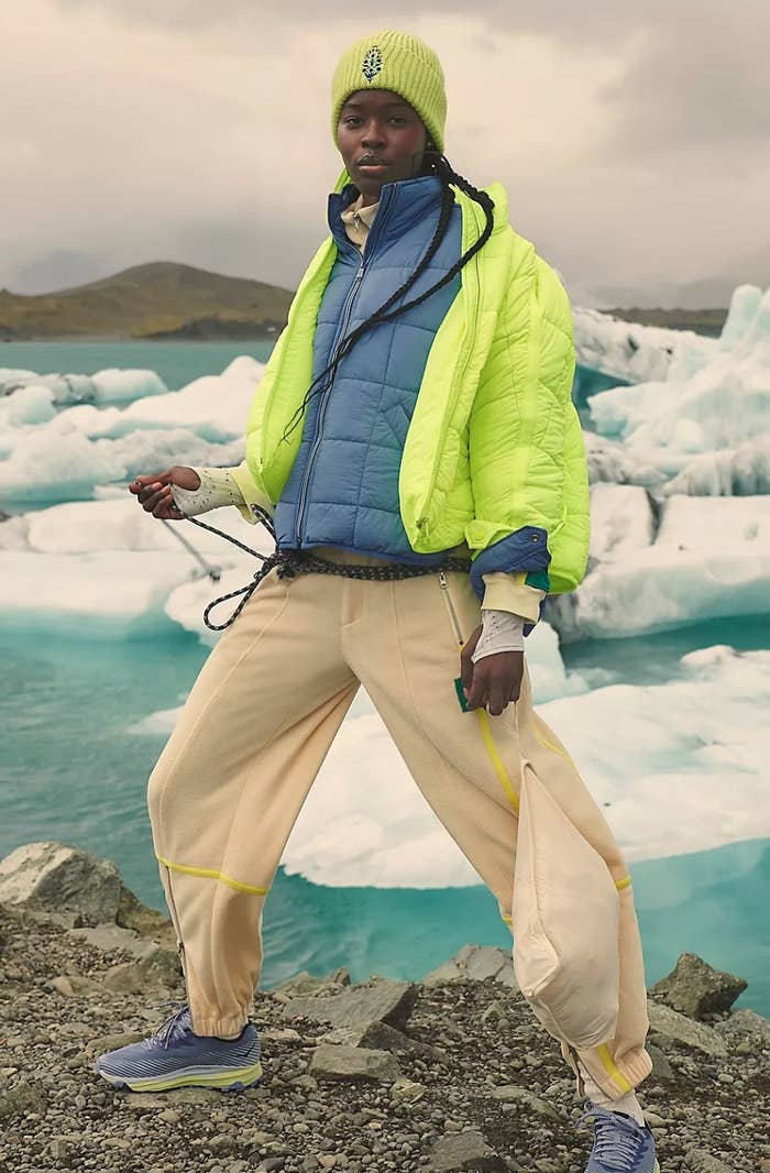 a model on an iceberg wearing the bright yellow puffer jacket