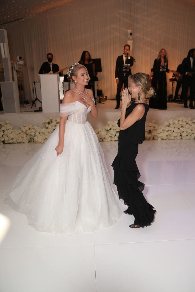 Paris Hilton in a wedding dress, laughing with Nicole Richie