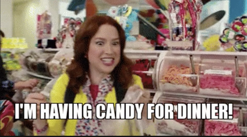 A woman in a candy shop with the text, &quot;I&#x27;m having candy for dinner!&quot;