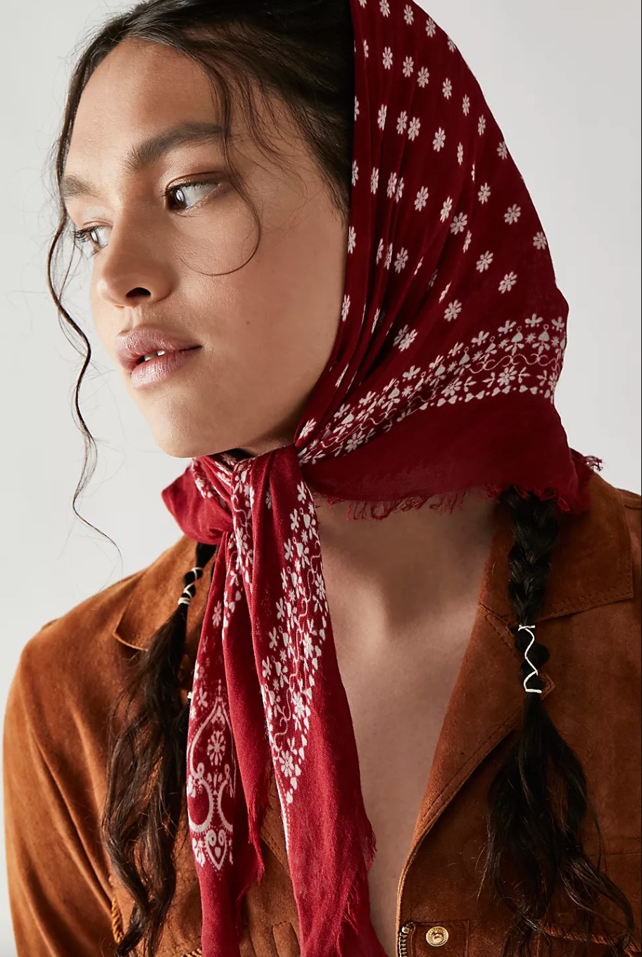 a model wearing the red bandana as a headscarf