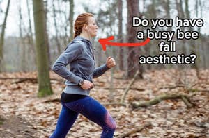 A woman runs through a forest in fall