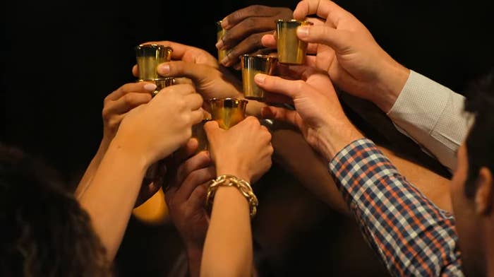 Cast members of Love Is Blind toast gold shot glasses