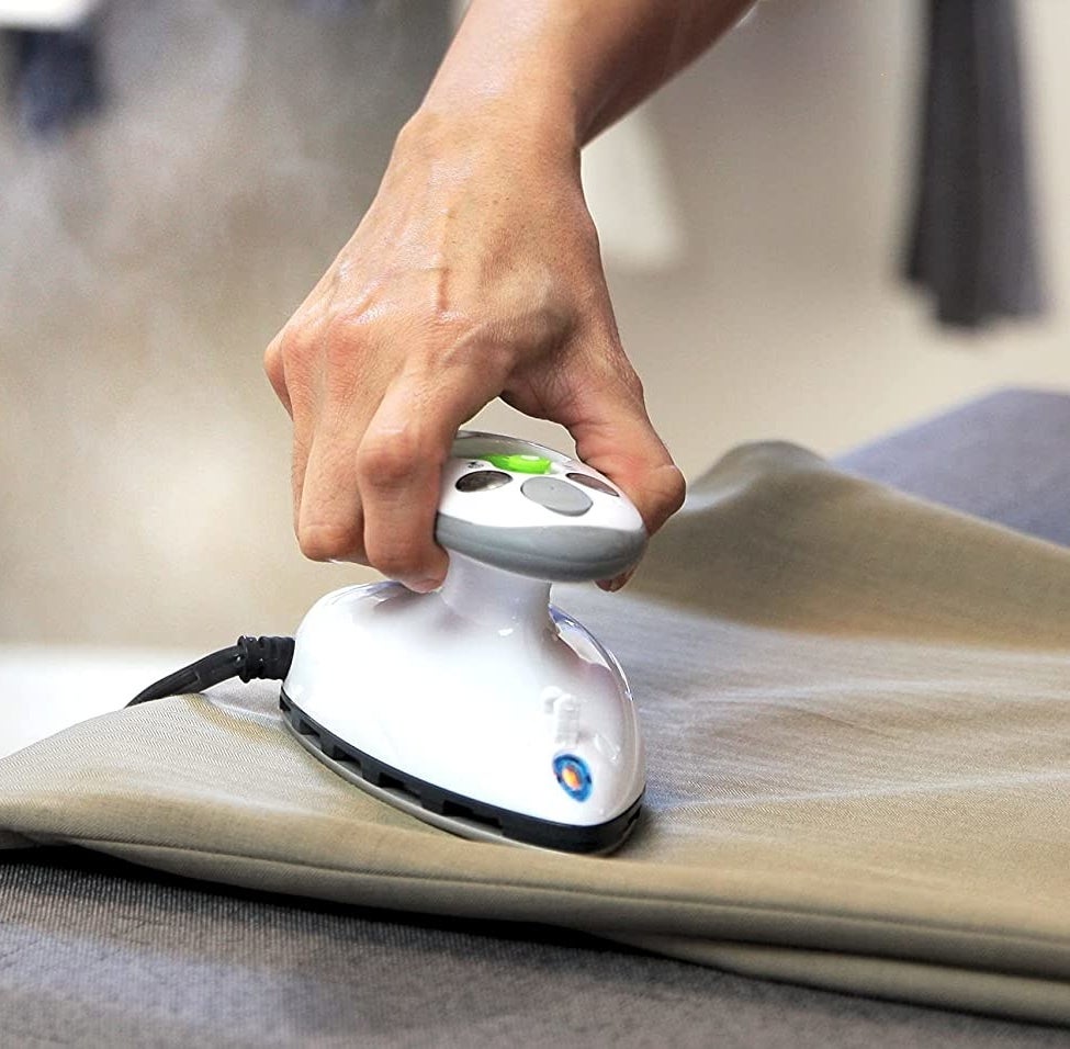person steaming their pants with the iron