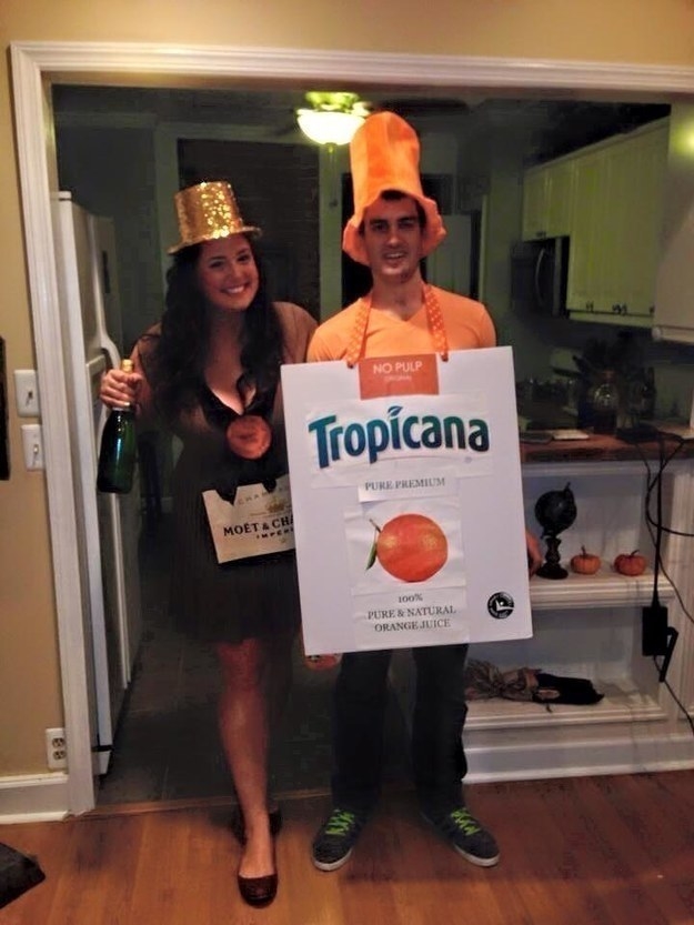 A couple dressed as champagne and orange juice