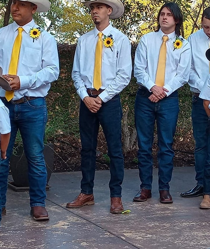 a reviewer photo of three people wearing the yellow ties in a wedding ceremony