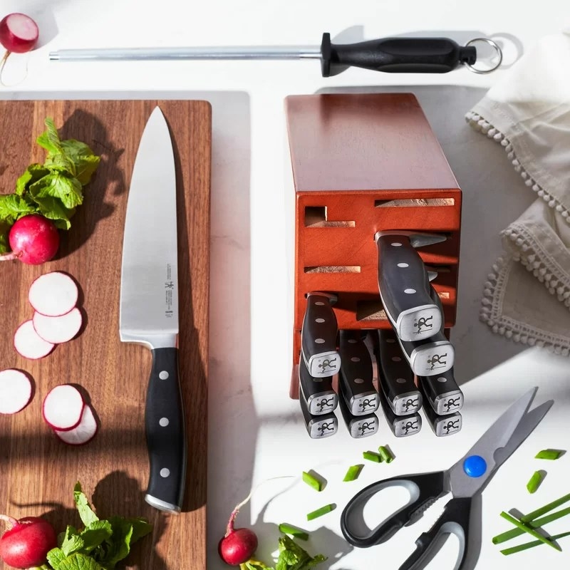 Knife block set next to cutting board and radishes