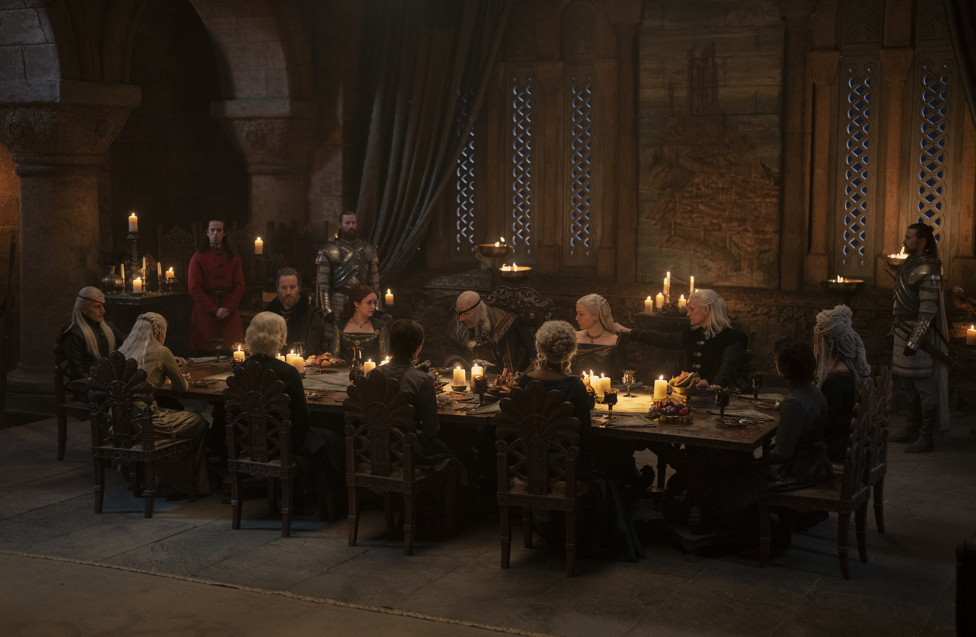 Viserys and his family sit around a long dinner table