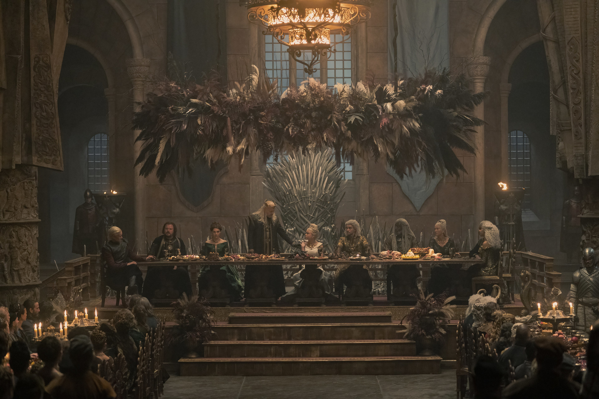 Viserys stands next to Rhaenyra at the head table during Rhaenyra and Laenor&#x27;s engagement feast in the Throne Room
