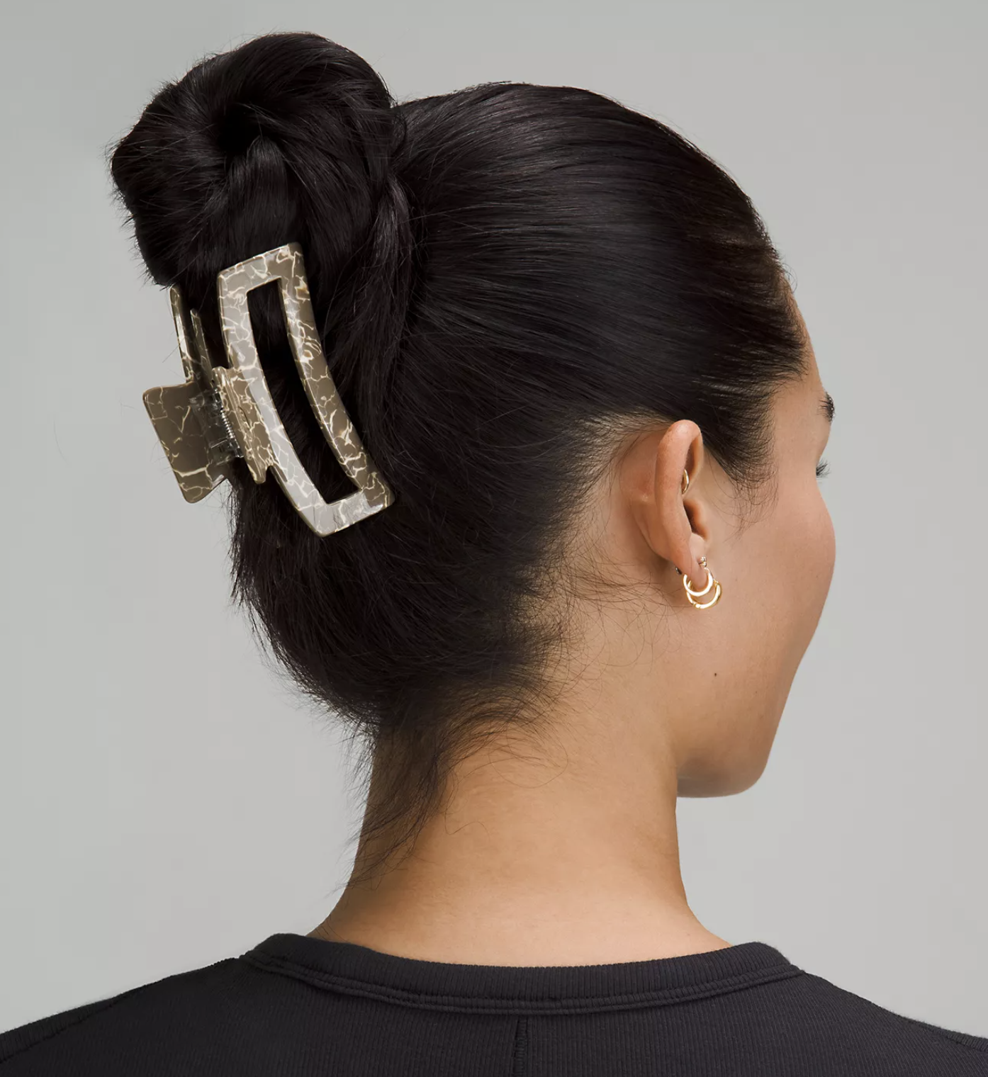 A person with their hair being held back with the claw clip
