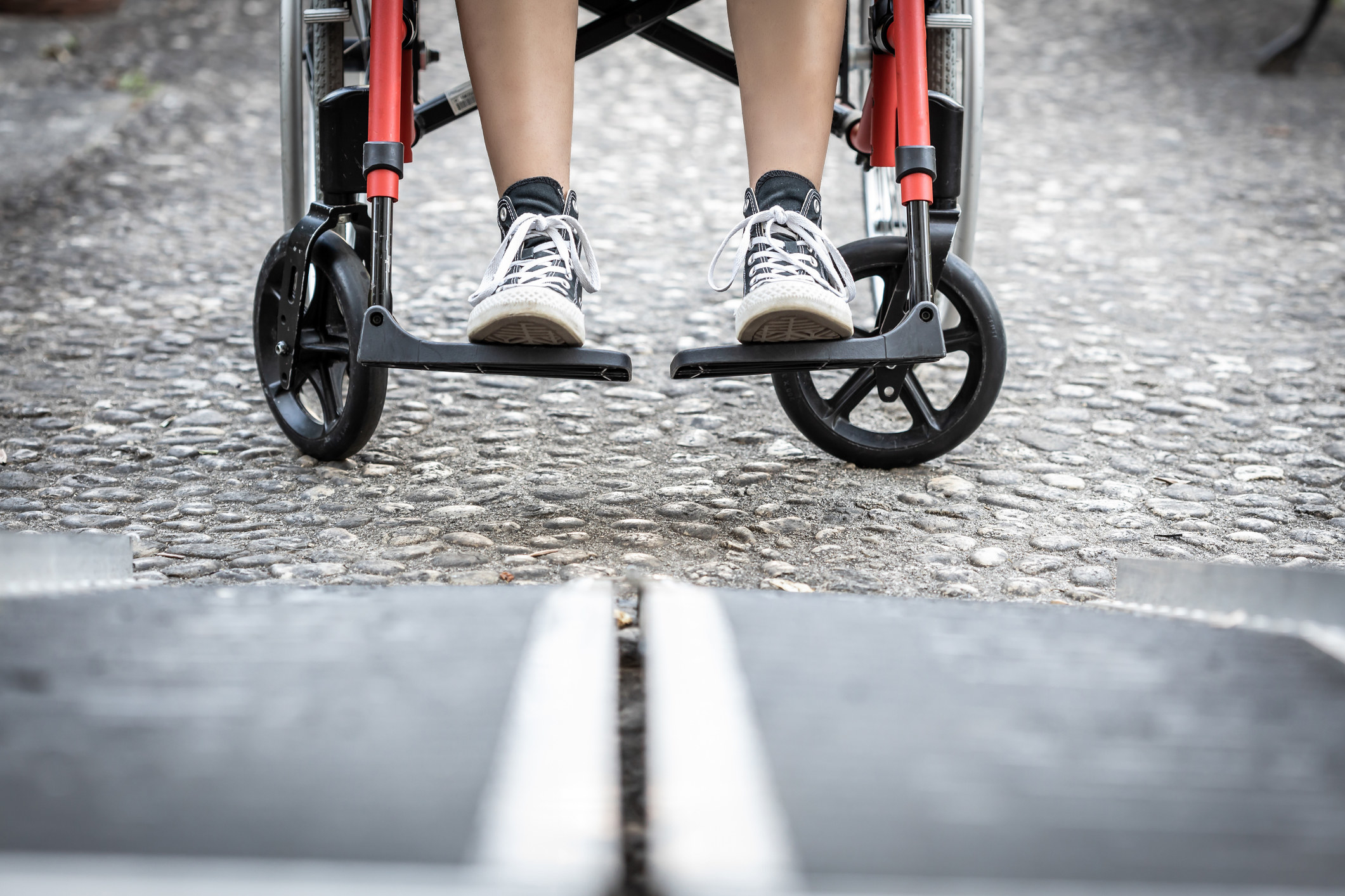 A person in a wheelchair boarding a ramp