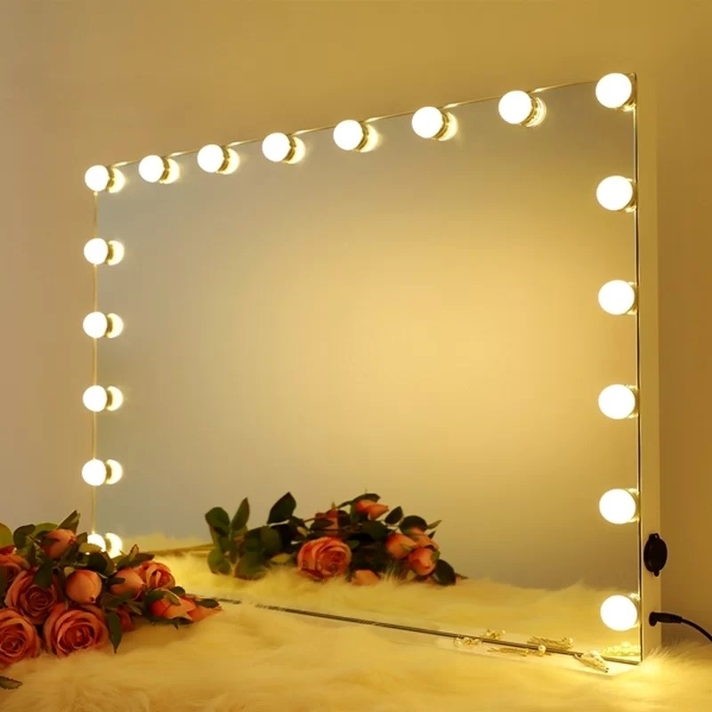 Mirror with LED lights on with flower in front