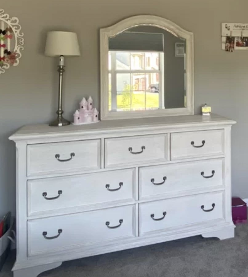 reviewer&#x27;s photo of the cream coastal dresser in room