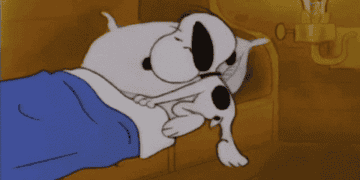 Snoopy crawling into bed and turning out light with heart rising from his head
