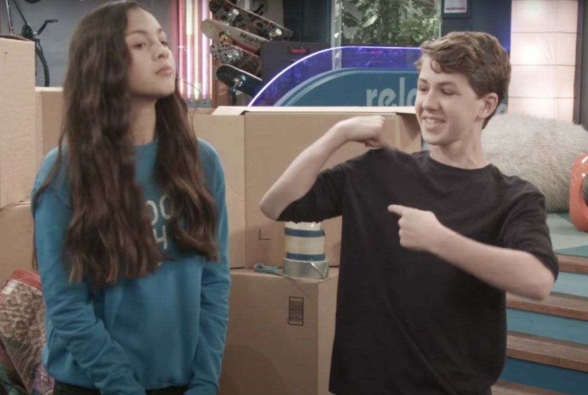 two teens in front of moving boxes