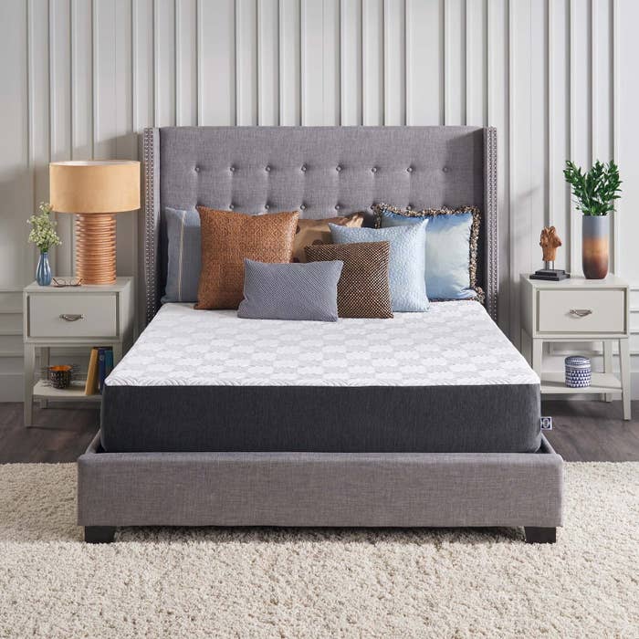 SealyCool 10' mattress styled on a bed frame with throw pillows and accent furniture