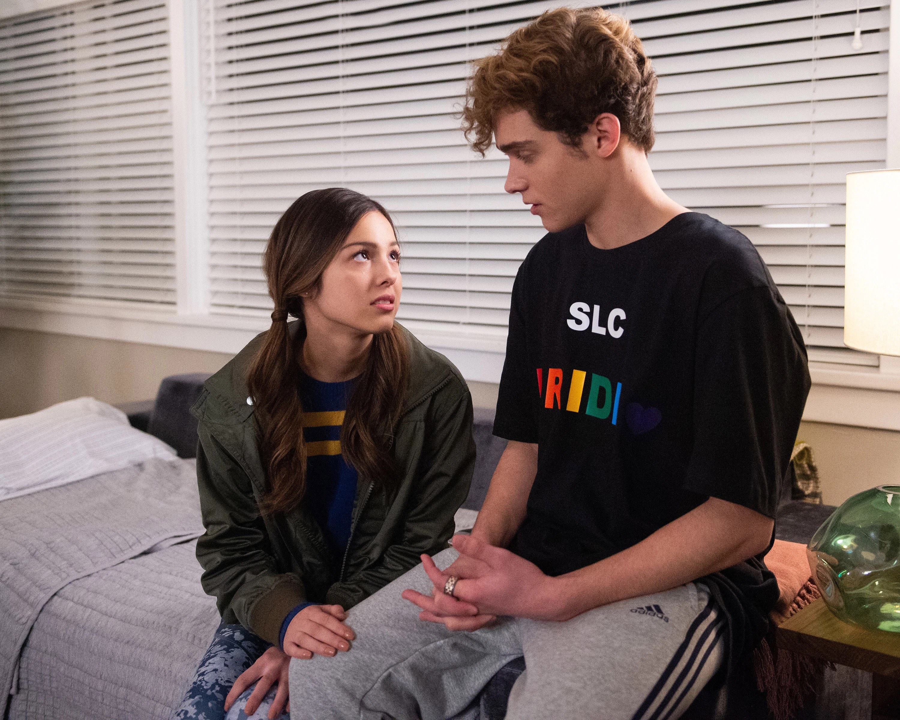 two teens talking on a pull out sofa