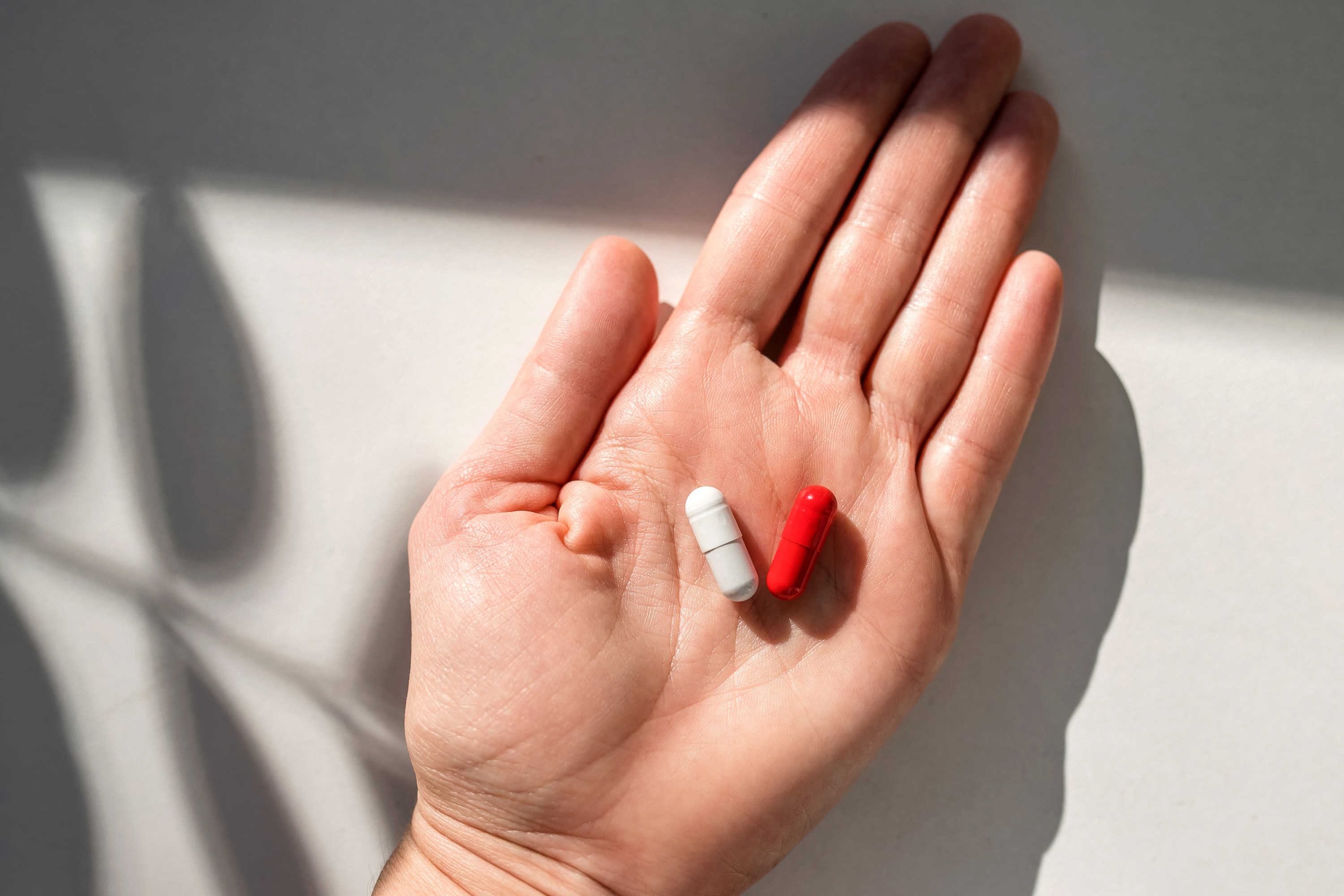 a person holding two pills