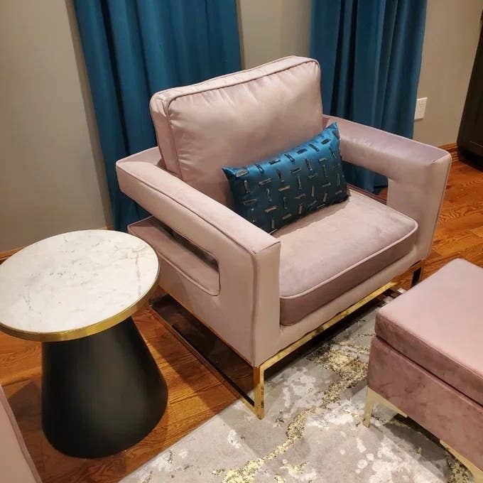 A pink chair with blue cushion in reviewer&#x27;s home