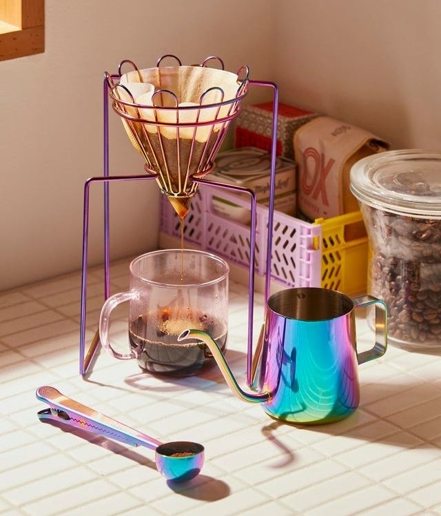 a coffee making kit including a drip stand, kettle, and scoop