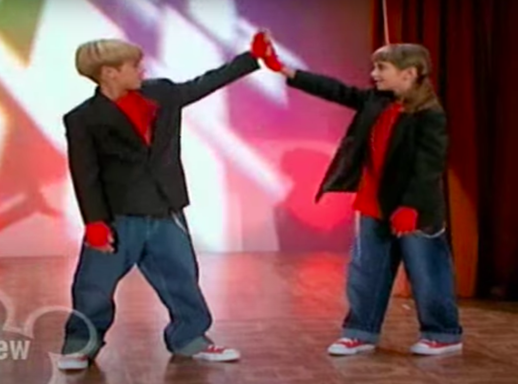 two kids high-fiving on stage