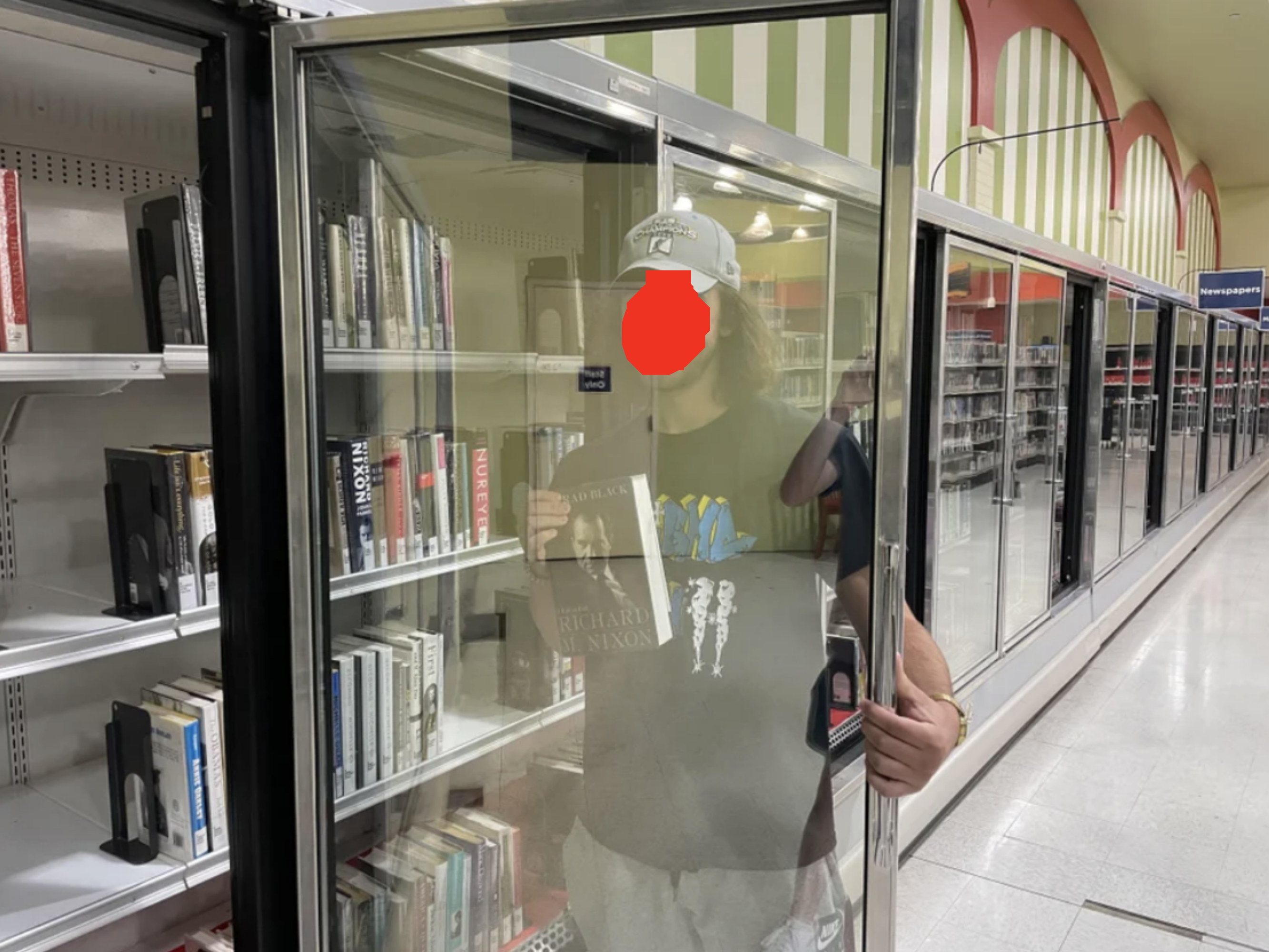 The books are set on shelves inside what used to be frozen section freezers