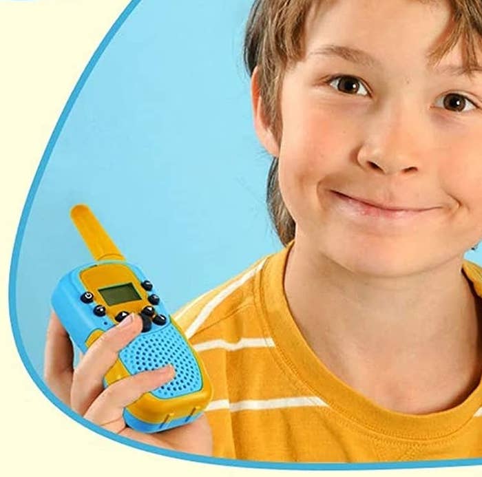 a kid holding a walkie-talkie