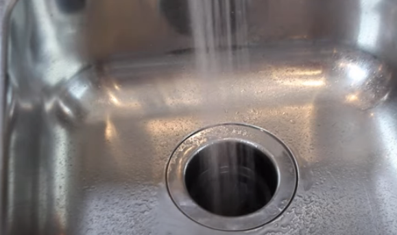 water going down garbage disposal