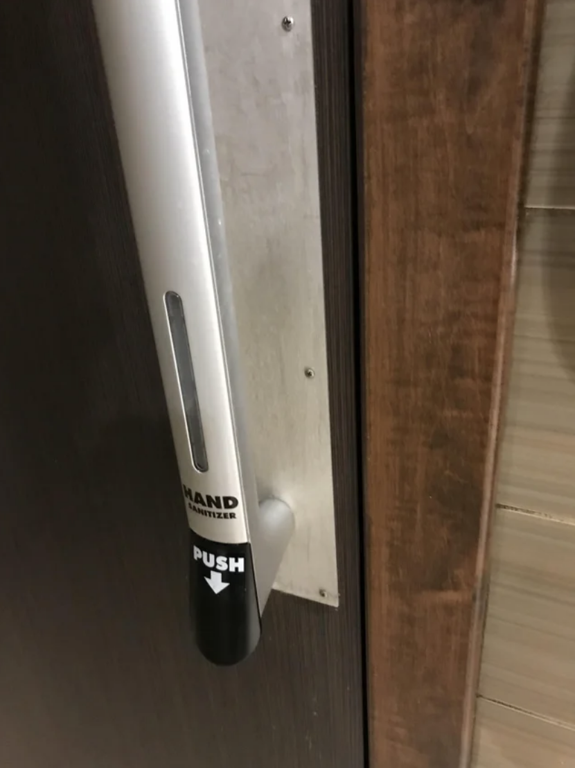 A hand sanitizer dispenser on a door handle to sanitize your hands after opening the door
