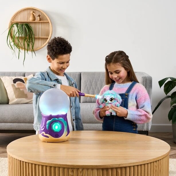 two kids playing with the magic crystal ball in a living room