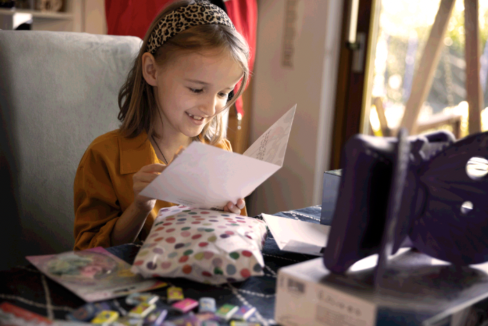 A little girl reading her birthday card