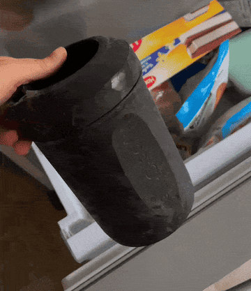 A gif of the writer putting the Hyper Chiller in the freezer