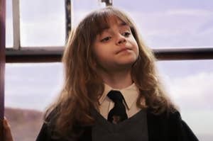 Young Hermione looking up, smugly