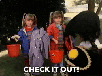 gif of olsen twins saying &quot;check it out&quot; with their halloween candy