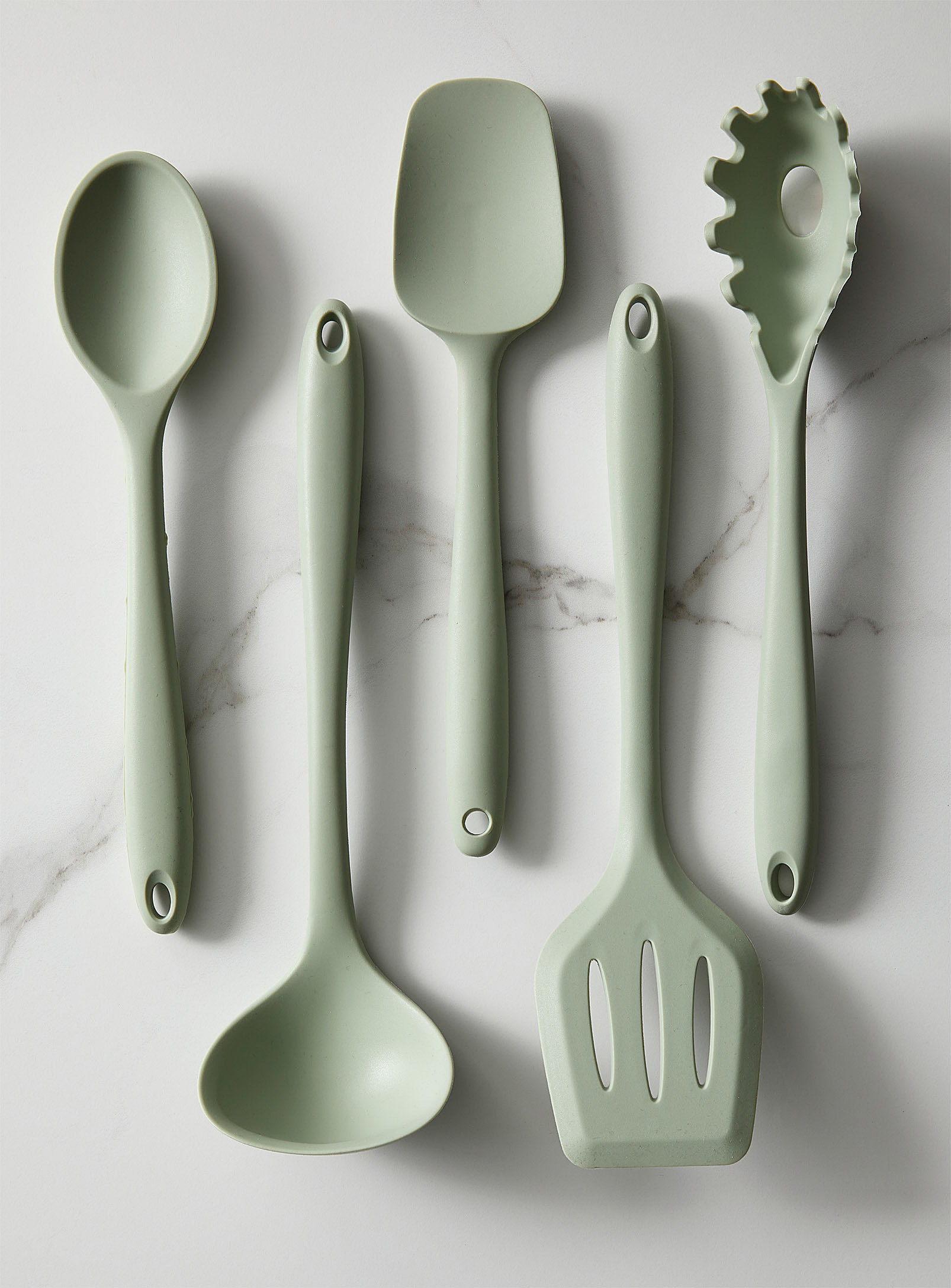 five utensils on a marble counter