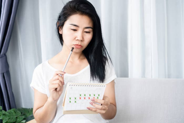 woman tracking her period on a calendar