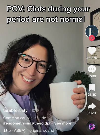 Tara smiling and holding a coffee cup