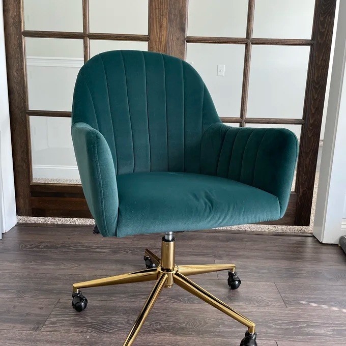a reviewer photo of the green velvet chair with gold base