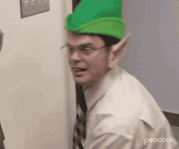 Gif of Dwight Schrute from the office wearing an elf hat and ears giving a thumbs up
