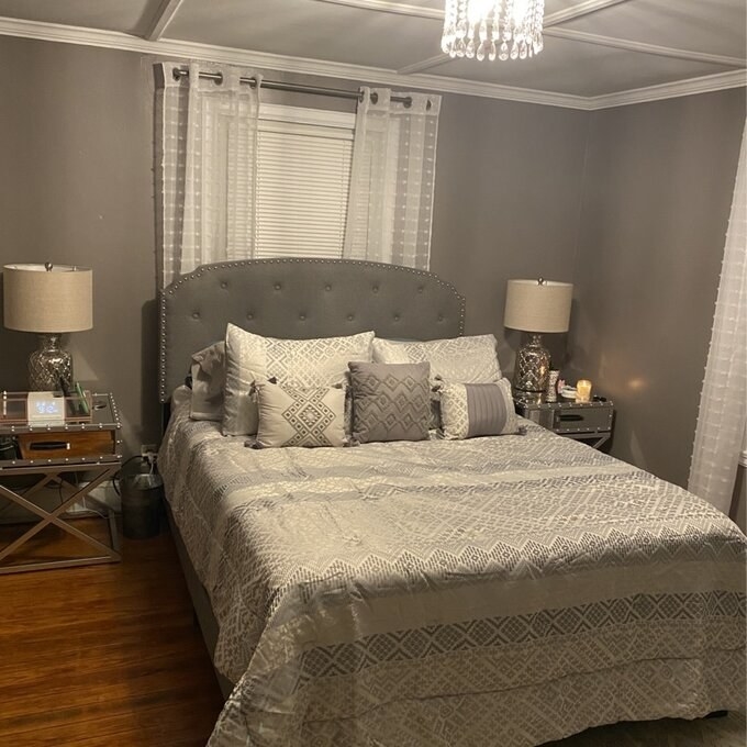 Gray upholstered bed in bedroom