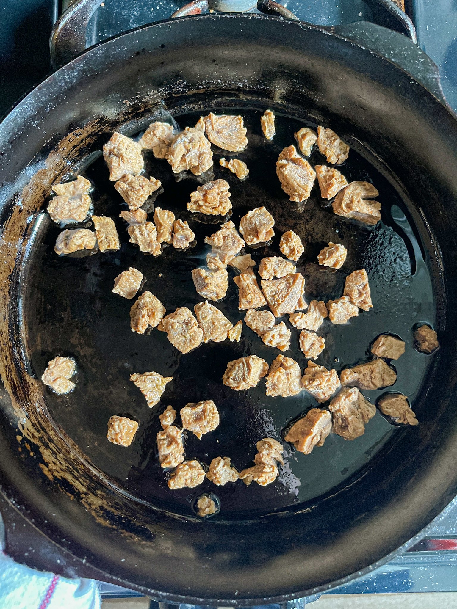 frozen pieces in a hot cast iron skillet