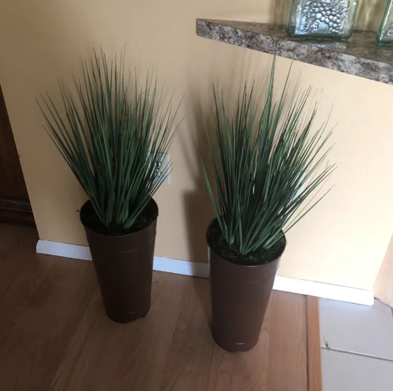 the faux grass pot on an end table