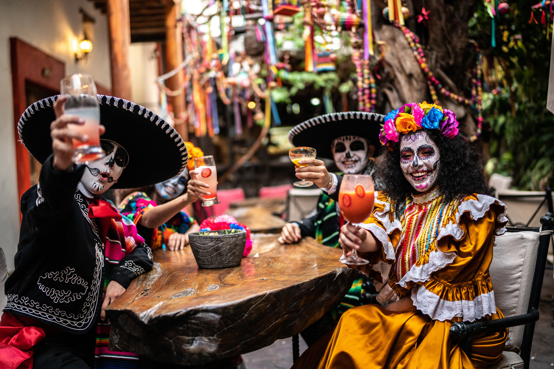 People drinking in mexican traditional clothes