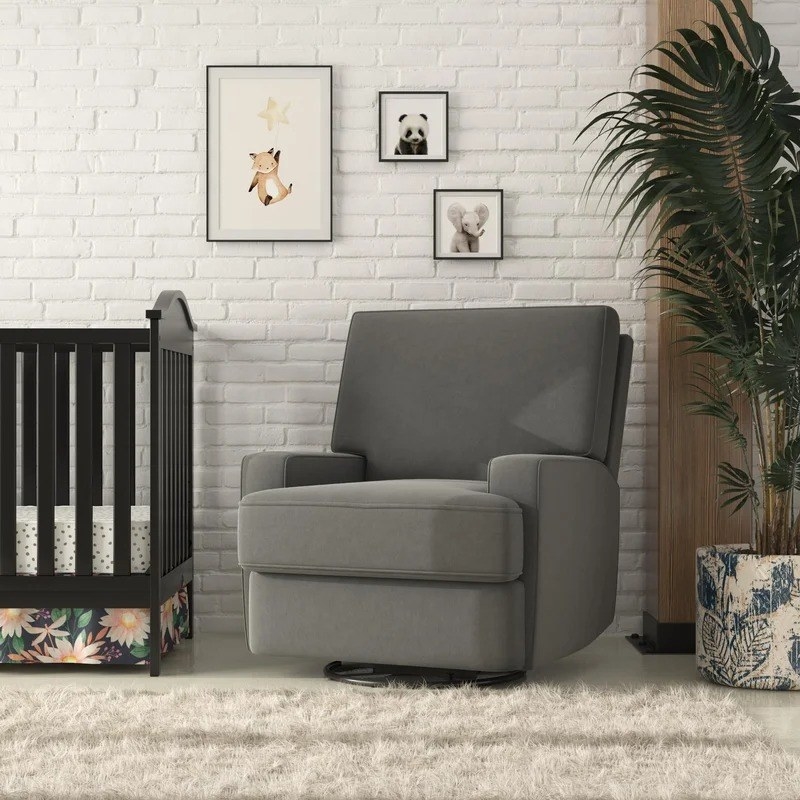 the dark gray chair next to a crib