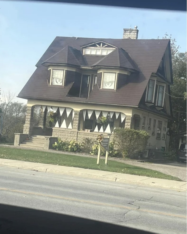 the windows look like eyes and the porch looks like a grimacing smile