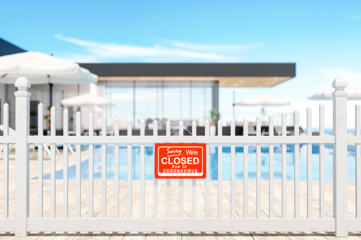 pool with a closed sign on the fence