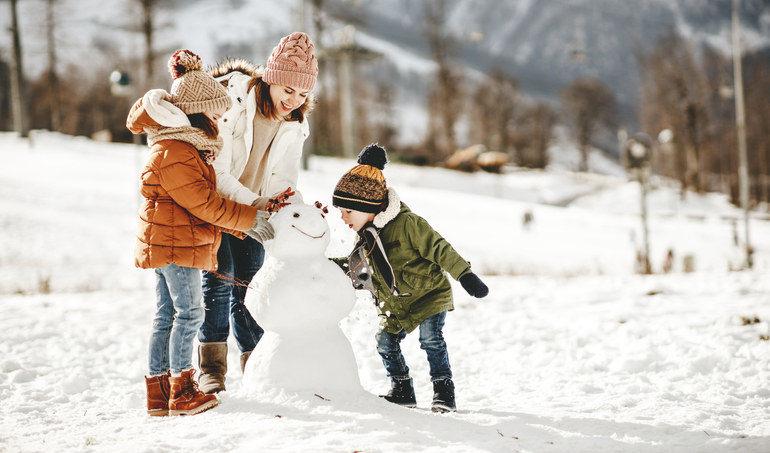 a family making a snowman