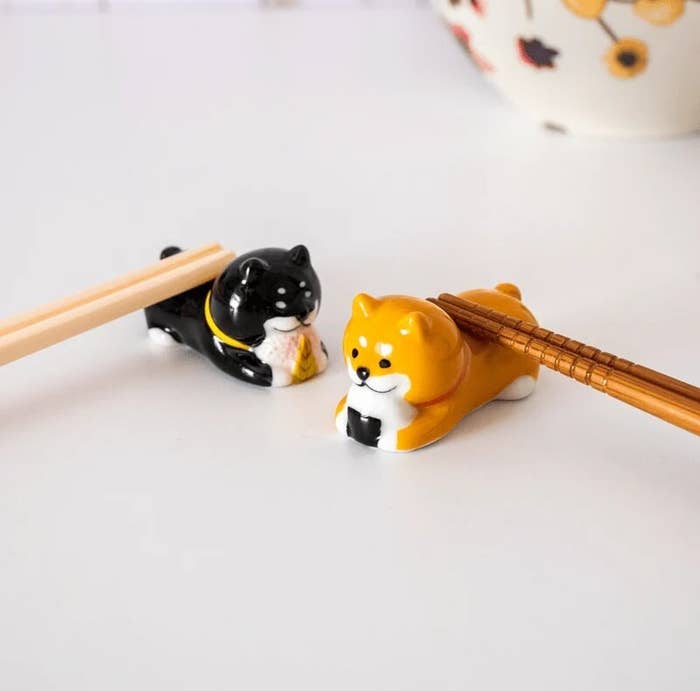 two chopstick holders with chopsticks resting on them