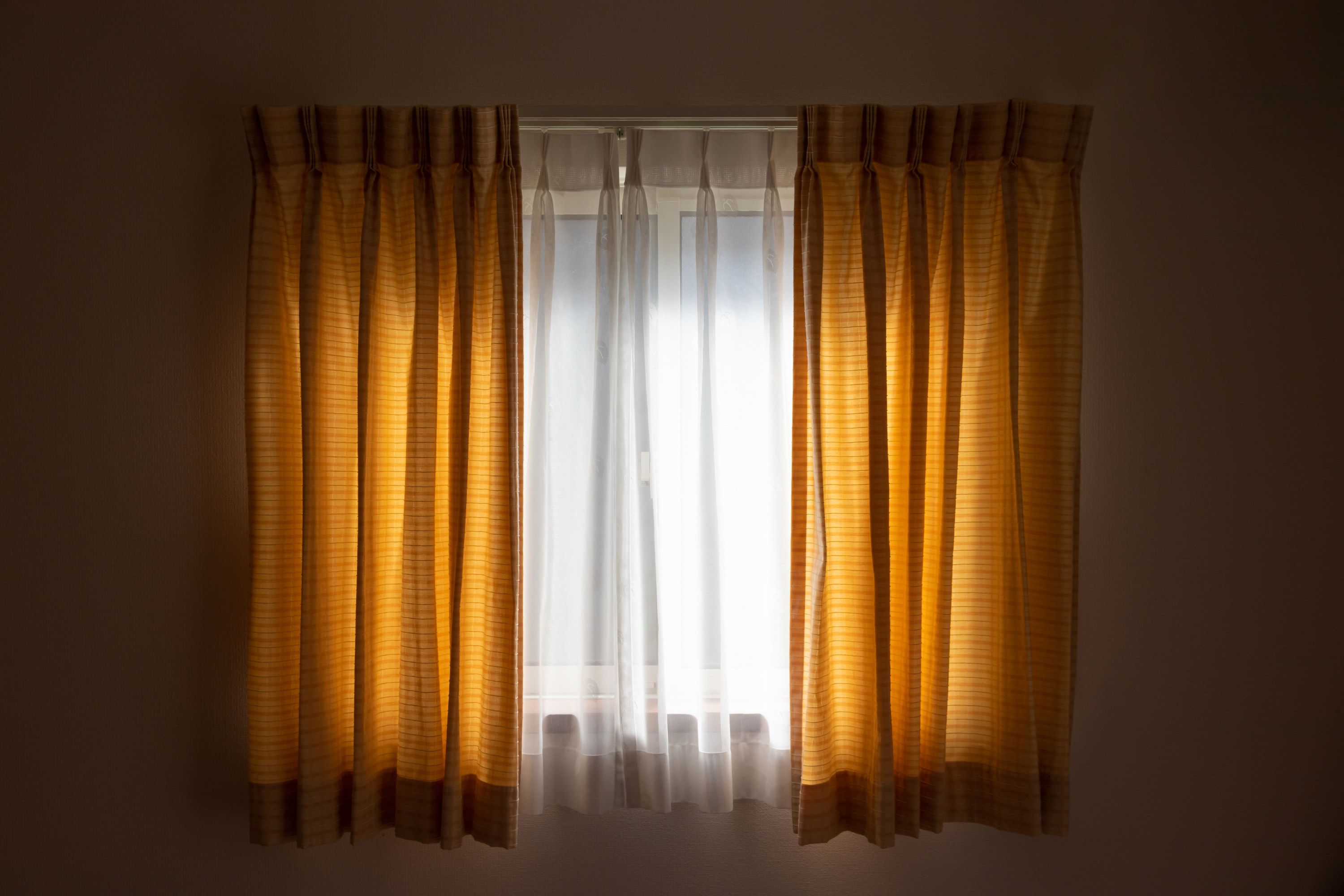 dark yellow curtains on a window