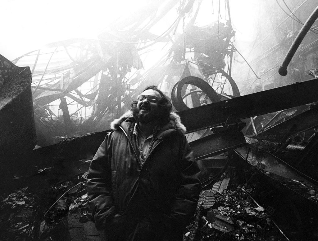 Kubrick during filming in front of the burned down rubble