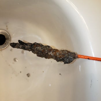 reviewer image of the end of the drain snake covered in hair and gunk